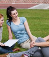 Happy students sitting together